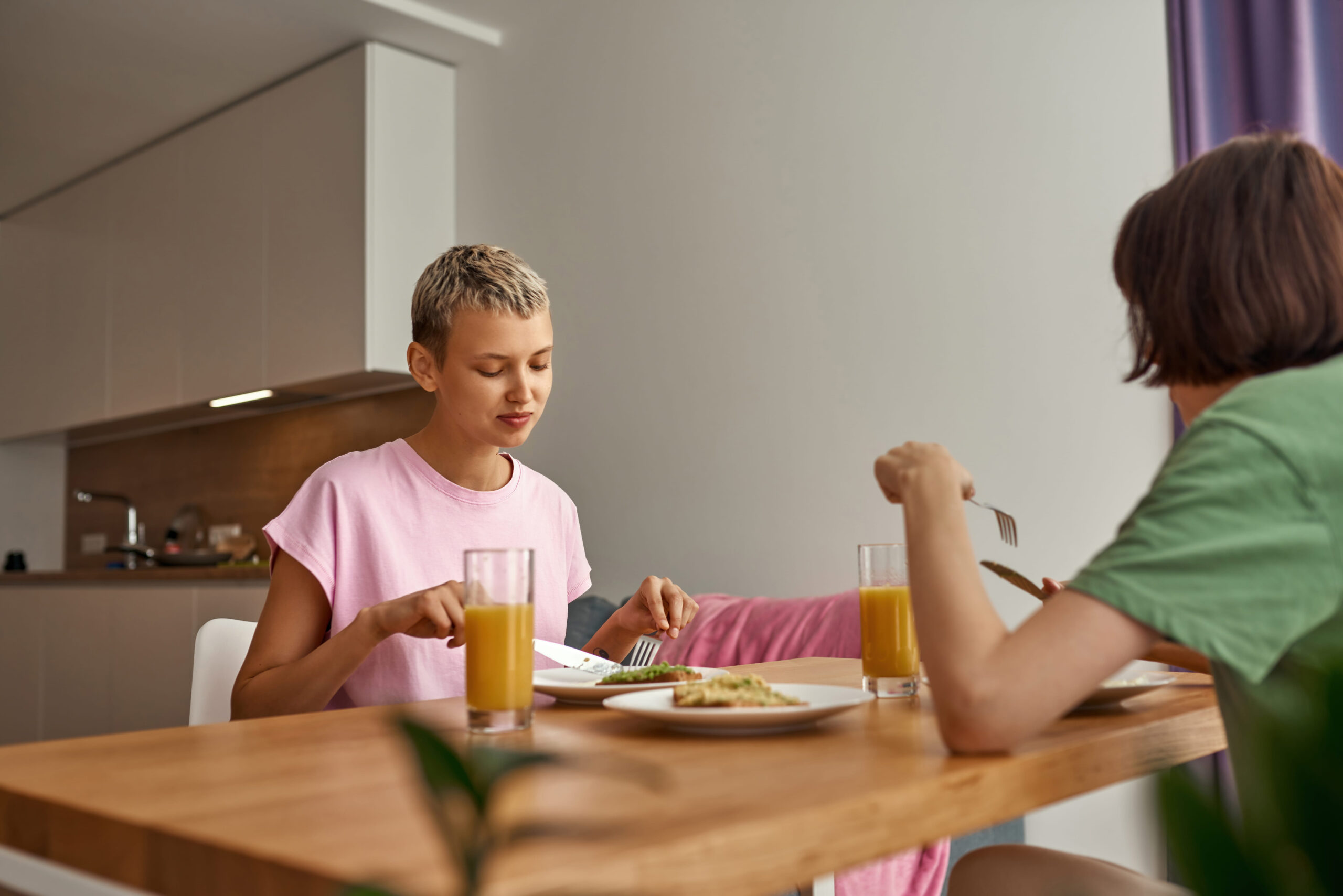 Young girls eating breakfast together.