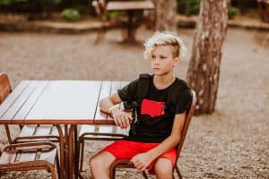 photo of a tween boy alone at a picnic table