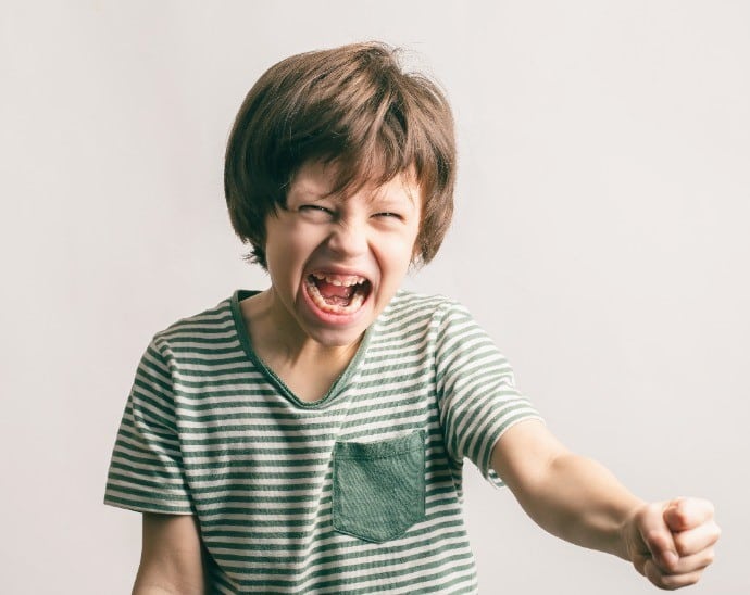 photo of angry child with clenched fist