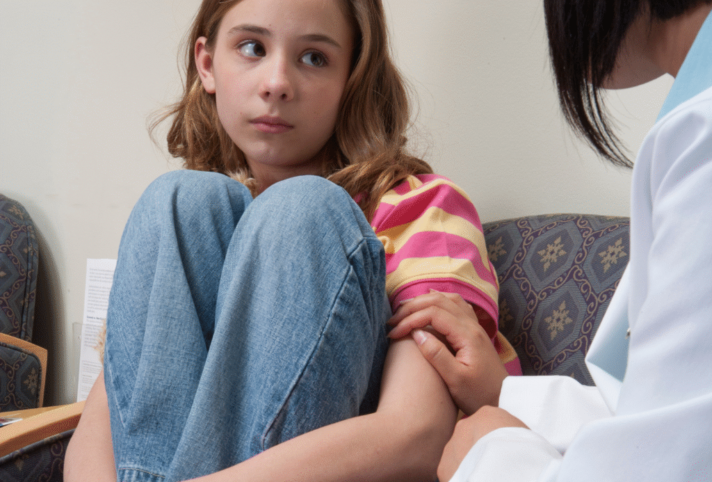 Provider comforting distressed teen.